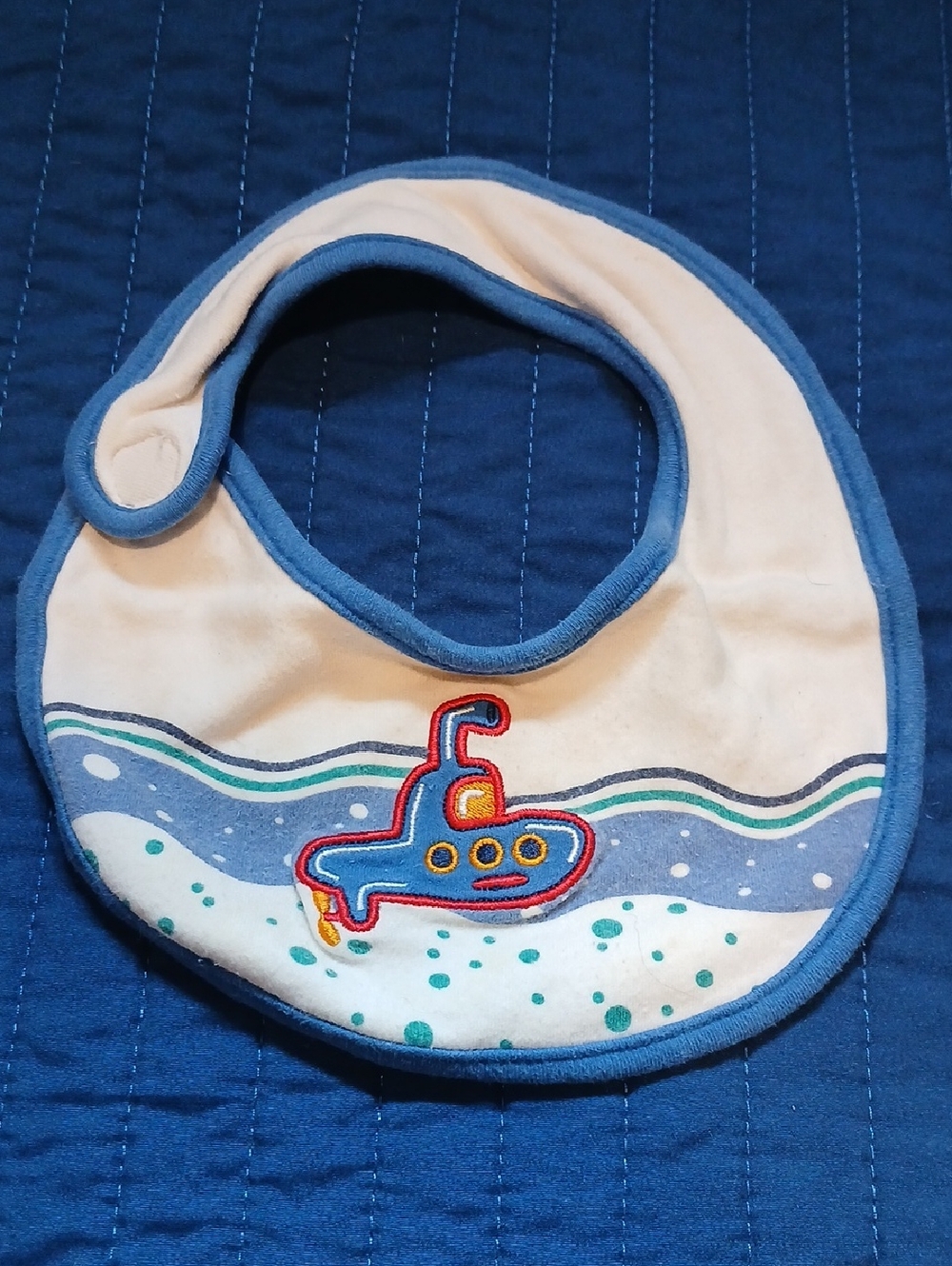 Bambini Cream Bib with Blue Trim and Submarine Applique